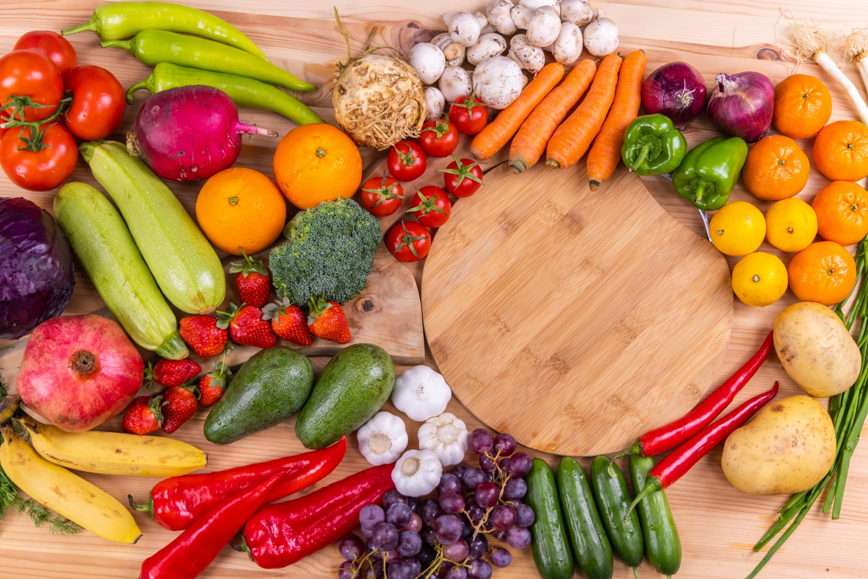 A vibrant display of fresh fruits and vegetables on a wooden board